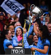 15 September 2019; Sinéad Goldrick, left, and Hannah O'Neill of Dublin lift the the Brendan Martin Cup with Freya Bohan, daughter of Dublin manager Mick Bohan, following the TG4 All-Ireland Ladies Football Senior Championship Final match between Dublin and Galway at Croke Park in Dublin. Photo by Stephen McCarthy/Sportsfile