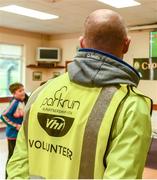 22 September 2019; Parkrun Ireland partnership with Vhi, expanded their range of junior events to 22 with the introduction of the Crosserlough Junior parkrun on Sunday morning. Junior parkruns are 2km long and cater for 4 to 14-year olds, free of charge providing a fun and safe environment for children to enjoy exercise. To register for a parkrun near you visit www.parkrun.ie. Volunteer John Connolly keeping an eye on the Ireland rugby game during the Crosserlough junior parkrun in partnership with Vhi at Crosserlough GAA Club in Kilnaleck, Co. Cavan. Photo by Philip Fitzpatrick/Sportsfile
