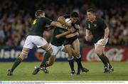 8 November 2003; Mils Muliaina, New Zealand, in action against Bakkies Botha, left, Derick Hougaard, centre, and Faan Rautenbach, South Africa. 2003 Rugby World Cup, Quarter Final, New Zealand v South Africa, Telstra Dome, Melbourne, Victoria, Australia. Picture credit; Brendan Moran / SPORTSFILE *EDI*