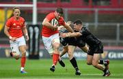 28 September 2019; Jack O'Donoghue of Munster is tackled by Owen Jenkins, right, and Jack Dixon of Dragons  during the Guinness PRO14 Round 1 match between Munster and Dragons at Thomond Park in Limerick. Photo by Matt Browne/Sportsfile