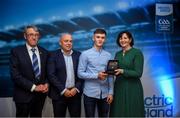 28 September 2019; Pictured is the Electric Ireland Minor Hurling All Star winner Ronan Lyons of Limerick at the 2019 Electric Ireland Minor Star Awards alongside, from left, Munster Council chairman Liam Lenihan, Derek McGrath and Executive Director of ESB Marguerite Sayers. The Hurling Team of the Year was selected by an expert panel of GAA legends including Alan Kerins, Derek McGrath, Karl Lacey and Tomás Quinn. The Electric Ireland GAA Minor Star Awards create a major moment for Minor players, showcasing the outstanding achievements of individual performers throughout the Championship season. The awards also recognise the effort of those who support them day in and day out, from their coaches to parents, clubs and communities. #GAAThisIsMajor Photo by David Fitzgerald/Sportsfile