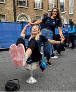 29 September 2019; Dublin footballer Nicole Owens sits in the Brendan Martin cup while her team-mate Niamh Hetherton stands behind her during the Dublin Senior Football teams homecoming at Merrion Square in Dublin. Photo by David Fitzgerald/Sportsfile