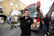 29 September 2019; Michael Darragh Macauley gets off the bus with the Sam Maguire Cup during the Dublin Senior Football teams homecoming at Merrion Square in Dublin. Expressway as official carriers of the Dublin senior football team are proud to have carried the Dubs to a historic 5 in a row. Expressway has been official carriers of Dublin GAA since 2015 and each year since Dublin have won the Sam Maguire trophy. Photo by David Fitzgerald/Sportsfile