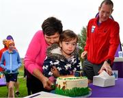 5 October 2019; Amy Cranley, age 2, helps volunteer Liz O'Dwyer cut the event birthday cake at the Father Collins parkrun at Father Collins park, The Hole in The Wall Rd, Dublin, where Vhi hosted a special event to celebrate their partnership with parkrun Ireland. Olympian Mick Clohisey was on hand to lead the warm up for parkrun participants before completing the 5km free event. Parkrunners enjoyed refreshments post event at the Vhi Rehydrate, Relax, Refuel and Reward areas. Parkrun in partnership with Vhi support local communities in organising free, weekly, timed 5k runs every Saturday at 9.30am. To register for a parkrun near you visit www.parkrun.ie. Photo by Seb Daly/Sportsfile