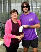 5 October 2019; Volunteer Liz O'Dwyer is presented with an award by Olympian Mick Clohisey ahead of the Father Collins parkrun at Father Collins park, The Hole in The Wall Rd, Dublin, where Vhi hosted a special event to celebrate their partnership with parkrun Ireland. Mick was on hand to lead the warm up for parkrun participants before completing the 5km free event. Parkrunners enjoyed refreshments post event at the Vhi Rehydrate, Relax, Refuel and Reward areas. Parkrun in partnership with Vhi support local communities in organising free, weekly, timed 5k runs every Saturday at 9.30am. To register for a parkrun near you visit www.parkrun.ie. Photo by Seb Daly/Sportsfile