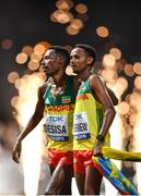 5 October 2019; Lelisa Desisa of Ethiopia, left, is helped to his feet by team-mate Mosinet Geremew after winning the Men's Marathon during day nine of the 17th IAAF World Athletics Championships Doha 2019 at the Corniche in Doha, Qatar. Photo by Sam Barnes/Sportsfile