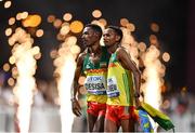 5 October 2019; Lelisa Desisa of Ethiopia, left, is helped to his feet by team-mate Mosinet Geremew after winning the Men's Marathon during day nine of the 17th IAAF World Athletics Championships Doha 2019 at the Corniche in Doha, Qatar. Photo by Sam Barnes/Sportsfile