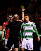 5 October 2019; Lewis Banks of Sligo Rovers and Graham Burke of Shamrock Rovers receive yellow cards from referee Graham Kelly during the SSE Airtricity League Premier Division match between Sligo Rovers and Shamrock Rovers at The Showgrounds in Sligo. Photo by Stephen McCarthy/Sportsfile