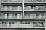 15 October 2019; A resident tends to his washing in an apartment overlooking Ireland Rugby squad training in Arcs Urayasu Park in Urayasu, Aichi, Japan. Photo by Brendan Moran/Sportsfile