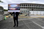 16 October 2019; A member of the Tokyo 2020 organising Committee staff holds up artists impressions of the finished Tokyo Olympic Stadium, Tokyo 2020 Summer Olympic Games venue for the opening and closing ceremonies, football and athletics, during the Tokyo 2nd World Press Briefing venue tour ahead of the 2020 Tokyo Summer Olympic Games. The Tokyo 2020 Games of the XXXII Olympiad take place from Friday 24th July to Sunday 9th August 2020 in Tokyo, Japan, the second Summer Olympics Games to be held in Tokyo, the first being 1964. Photo by Brendan Moran/Sportsfile