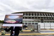 16 October 2019; A member of the Tokyo 2020 organising Committee staff holds up artists impressions of the finished Tokyo Olympic Stadium, Tokyo 2020 Summer Olympic Games venue for the opening and closing ceremonies, football and athletics, during the Tokyo 2nd World Press Briefing venue tour ahead of the 2020 Tokyo Summer Olympic Games. The Tokyo 2020 Games of the XXXII Olympiad take place from Friday 24th July to Sunday 9th August 2020 in Tokyo, Japan, the second Summer Olympics Games to be held in Tokyo, the first being 1964. Photo by Brendan Moran/Sportsfile