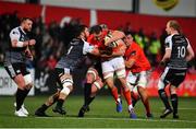 25 October 2019; Tommy O'Donnell of Munster is tackled by Gareth Evans, left and Dan Lydiate, hidden, both of Ospreys during the Guinness PRO14 Round 4 match between Munster and Ospreys at Irish Independent Park in Cork. Photo by Sam Barnes/Sportsfile