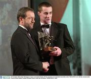 28 November 2003; Brian McGuigan, Tyrone, is presented with his All-Star award by GAA President Sean Kelly at the VODAFONE GAA All-Star Awards in the Citywest Hotel, Dublin. Football. Hurling. Picture credit; Ray McManus / SPORTSFILE *EDI*