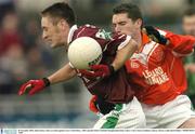 30 November 2003; John Galvin, Caltra, in action against Curry's Paul Henry. AIB Connacht Senior Football Championship Final, Caltra v Curry, Pearse Stadium, Galway. Picture credit; David Maher / SPORTSFILE *EDI*