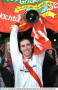 30 November 2003; An Ghaeltacht captain Darragh O'Se lifts the cup after victory over St. Senan's. AIB Munster Senior Football Championship Final, An Ghaeltacht v St. Senan's, Gaelic Grounds, Limerick. Picture credit; Brendan Moran / SPORTSFILE *EDI*