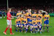 23 June 2013; Jason Hankard, Fr O'Neills, Kilcredan, Cork, loans a few hurleys to his Clare opponents as they sit for a team photograph before the Primary Go Games. Munster GAA Hurling Senior Championship Semi-Final, Cork v Clare, Gaelic Grounds, Limerick. Picture credit: Ray McManus / SPORTSFILE