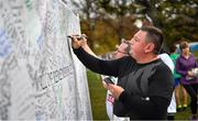 10 November 2019; A runner signs the 'Wall of Remembrance' following the Remembrance Run 5k at Phoenix Park in Dublin. Photo by David Fitzgerald/Sportsfile