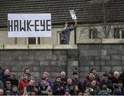 19 January 2019; Eyes like a hawk. A fan sets up an improvised Hawk-Eye, complete with Tá sign. Is anyone in the crowd in Enniscorthy taken in? Níl. In fact, they were enthralled by a fiery Walsh Cup final that featured four red cards and a 13-point haul for Joe Canning. Photo by Piaras Ó Mídheach/Sportsfile. This image may be reproduced free of charge when used in conjunction with a review of the book &quot;A Season of Sundays 2019&quot;. All other usage © SPORTSFILE