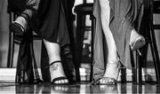 16 November 2019; (EDITOR'S NOTE: Image has been converted to black & white) A tattoo is seen on the foot of Monica McGuirk of Meath sitting alongside Sinead Burke of Galway during the TG4 All-Ireland Ladies Football All Stars Awards banquet, in association with Lidl, at the Citywest Hotel in Saggart, Dublin. Photo by Brendan Moran/Sportsfile