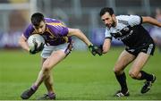 17 November 2019; Garvan Jones of Derrygonnelly in action against Aidan Branagan of Kilcoo during the AIB Ulster GAA Football Senior Club Championship semi-final match between Kilcoo and Derrygonnelly at the Athletic Grounds in Armagh. Photo by Oliver McVeigh/Sportsfile