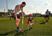 29 November 2019; Antrim's Neil McManus of 2019 PwC All-Star with seven year old Daithi Walsh during a coaching session before the PwC All Star Hurling Tour 2019 All Star game at Zayed Sport City in Abu Dhabi, United Arab Emirates. Photo by Ray McManus/Sportsfile