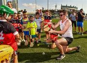 29 November 2019; Donegal's Declan Coulter of 2018 PwC All-Star teamwith local children during a coaching session before the PwC All Star Hurling Tour 2019 All Star game at Zayed Sport City in Abu Dhabi, United Arab Emirates. Photo by Ray McManus/Sportsfile