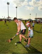 29 November 2019; Clare's John Conlon of 2018 PwC All-Star team with local child Eliana Brennan, seven years, during a coaching session before the PwC All Star Hurling Tour 2019 All Star game at Zayed Sport City in Abu Dhabi, United Arab Emirates. Photo by Ray McManus/Sportsfile