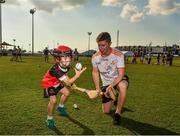 29 November 2019; Sligo's James Weir of 2019 PwC All-Star team with seven year old Daithi Walsh during a coaching session before the PwC All Star Hurling Tour 2019 All Star game at Zayed Sport City in Abu Dhabi, United Arab Emirates. Photo by Ray McManus/Sportsfile