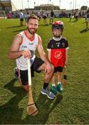 29 November 2019; Antrim's Neil McManus of 2019 PwC All-Star with seven year old Daithi Walsh during a coaching session before the PwC All Star Hurling Tour 2019 All Star game at Zayed Sport City in Abu Dhabi, United Arab Emirates. Photo by Ray McManus/Sportsfile