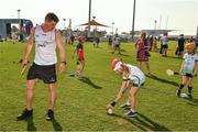 29 November 2019; Clare's John Conlon of 2018 PwC All-Star team with local child Eliana Brennan, seven years, during a coaching session before the PwC All Star Hurling Tour 2019 All Star game at Zayed Sport City in Abu Dhabi, United Arab Emirates. Photo by Ray McManus/Sportsfile