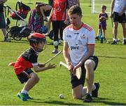 29 November 2019; Sligo's James Weir of 2019 PwC All-Star team with seven year old Daithi Walsh during a coaching session before the PwC All Star Hurling Tour 2019 All Star game at Zayed Sport City in Abu Dhabi, United Arab Emirates. Photo by Ray McManus/Sportsfile