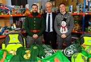 8 December 2019; Republic of Ireland manager Mick McCarthy was on hand today to hand over Republic of Ireland bags filled with jerseys, footballs, scarfs & other merchandise to St Vincent De Paul staff, at the St Vincent De Paul depot on Sean McDermott Street, Summerhill, Dublin. The gifts are part of an annual Christmas donation for families in need. Pictured are Republic of Ireland manager Mick McCarthy, centre, and Corporate Volunteers from Electric Ireland Joe Scully, left, and Emmet Higgins, at the St Vincent De Paul depot on Sean McDermott Street, Summerhill, Dublin. Photo by Seb Daly/Sportsfile