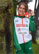 8 December 2019; Stephanie Cotter of Ireland poses for a photo with her team silver and individual bronze medal from the Women's U23 event during the European Cross Country Championships 2019 at Bela Vista Park in Lisbon, Portugal. Photo by Sam Barnes/Sportsfile