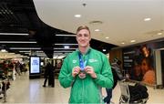 9 December 2019; Shane Ryan of Ireland with his bronze medal, from the Men’s 50m Backstroke, on his return from the European Short Course Swimming Championships 2019 in Scotland at Dublin Airport in Dublin. Photo by Piaras Ó Mídheach/Sportsfile