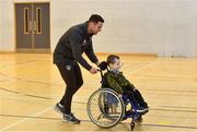 12 December 2019; FAI Development Officer Mark Connors with Tommy-Lee Stokes, from Scoil Mochua, Clondalkin, Dublin, during the FAI / SDCC Xmas Fun Day at Tallaght Leisure Centre in Dublin. Photo by Sam Barnes/Sportsfile