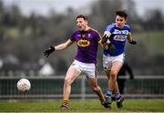 14 December 2019; Mark Rossiter of Wexford in action against Brian Byrne of Laois during the 2020 O'Byrne Cup Round 2 match between Wexford and Laois at St Patrick's Park in Enniscorthy, Wexford. Photo by Eóin Noonan/Sportsfile