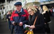 27 December 2019; Racegoers study the form prior to Day Two of the Leopardstown Christmas Festival 2019 at Leopardstown Racecourse in Dublin. Photo by David Fitzgerald/Sportsfile