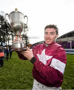 27 December 2019; Jack Kennedy celebrates with the trophy after winning the Paddy Power Steeplechase on Roaring Bull during Day Two of the Leopardstown Christmas Festival 2019 at Leopardstown Racecourse in Dublin. Photo by David Fitzgerald/Sportsfile