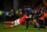 28 December 2019; James Lowe of Leinster is tackled by Dan Goggin of Munster during the Guinness PRO14 Round 9 match between Munster and Leinster at Thomond Park in Limerick. Photo by Ramsey Cardy/Sportsfile