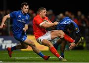 28 December 2019; Dan Goggin of Munster is tackled by Conor O'Brien, left, and James Lowe of Leinster during the Guinness PRO14 Round 9 match between Munster and Leinster at Thomond Park in Limerick. Photo by Ramsey Cardy/Sportsfile