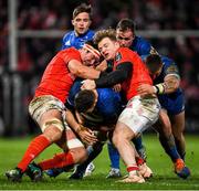 28 December 2019; Josh Murphy of Leinster is tackled by Chris Cloete, right, and Billy Holland of Munster during the Guinness PRO14 Round 9 match between Munster and Leinster at Thomond Park in Limerick. Photo by Ramsey Cardy/Sportsfile