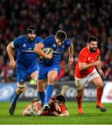 28 December 2019; Ross Byrne of Leinster beats the tackle by Billy Holland of Munster during the Guinness PRO14 Round 9 match between Munster and Leinster at Thomond Park in Limerick. Photo by Ramsey Cardy/Sportsfile