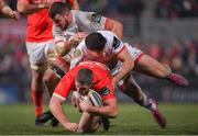 3 January 2020; Dan Goggin of Munster is tackled by Jacob Stockdale and Sean Reidy of Ulster during the Guinness PRO14 Round 10 match between Ulster and Munster at Kingspan Stadium in Belfast. Photo by Ramsey Cardy/Sportsfile