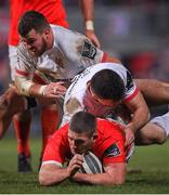 3 January 2020; Dan Goggin of Munster is tackled by Jacob Stockdale and Sean Reidy of Ulster during the Guinness PRO14 Round 10 match between Ulster and Munster at Kingspan Stadium in Belfast. Photo by Ramsey Cardy/Sportsfile