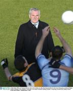 14 December 2003; An Taoiseach Bertie Ahern T.D. watches on, after throwing the ball in for the start of the game, as Darren Magee, Dublin, challanges Murt Kelleher, Underdogs. TG4 Senior Football Challenge, Dublin v Underdogs, Parnell Park, Dublin. Picture credit; David Maher / SPORTSFILE *EDI*