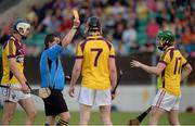 26 June 2013; Referee Gavin Quilty shows Conor Goff, 17, Wexford, his second yellow card, and subsequently sent him off. Bord Gáis Energy Leinster GAA Hurling Under 21 Championship Semi-Final, Wexford v Carlow, Dr. Cullen Park, Carlow. Picture credit: Brian Lawless / SPORTSFILE