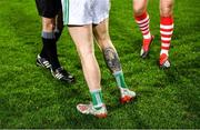 11 January 2020; A general view of the tattoo of Limerick captain Iain Corbett, centre, during the coin toss before the game with Cork captain Ian Maguire and referee Brendan Griffin at the McGrath Cup Final match between Cork and Limerick at LIT Gaelic Grounds in Limerick. Photo by Piaras Ó Mídheach/Sportsfile