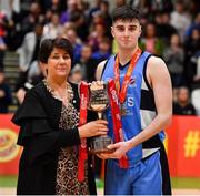 25 January 2020; Eli Lenihan of Neptune is presented with the cup by Basketball Ireland President Theresa Walsh after the Hula Hoops U18 Men’s National Cup Final between Neptune and Belfast Star at the National Basketball Arena in Tallaght, Dublin. Photo by Brendan Moran/Sportsfile