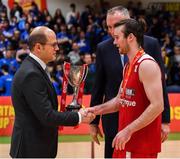 25 January 2020; Griffith College Templeogue captain Stephen James is presented with Pat Duffy cup by Secretary General of FIBA World Andreas Zagklis, left, and Secretary General of FIBA Europe Kamil Novak after the Hula Hoops Pat Duffy National Cup Final between DBS Éanna and Griffith College Templeogue at the National Basketball Arena in Tallaght, Dublin. Photo by Brendan Moran/Sportsfile