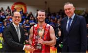 25 January 2020; Griffith College Templeogue captain Stephen James is presented with Pat Duffy cup by Secretary General of FIBA World Andreas Zagklis, left, and Secretary General of FIBA Europe Kamil Novak after the Hula Hoops Pat Duffy National Cup Final between DBS Éanna and Griffith College Templeogue at the National Basketball Arena in Tallaght, Dublin. Photo by Brendan Moran/Sportsfile